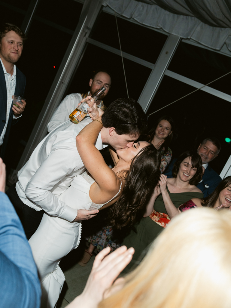 bride and groom kissing during their reception at Silver Swan Bayside
