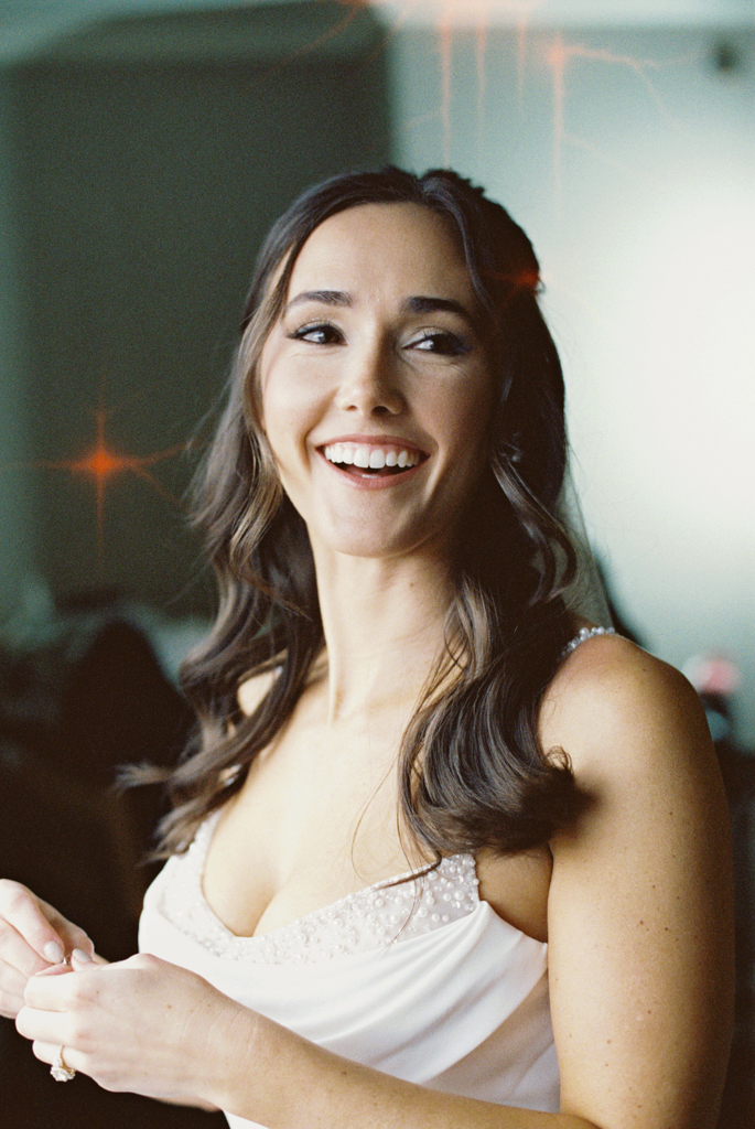 Bride laughing while getting ready before her first look at the Graduate Hotel Annapolis