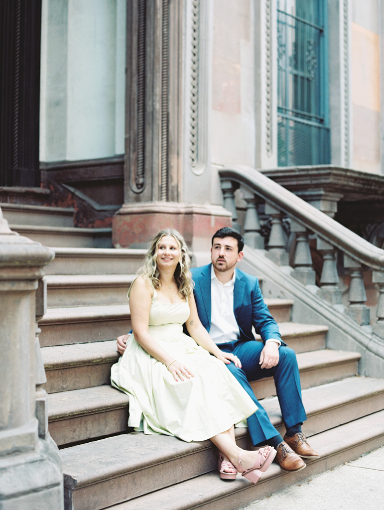 couple sitting on steps together in Mount Vernon Baltimore by Baltimore film wedding photographer