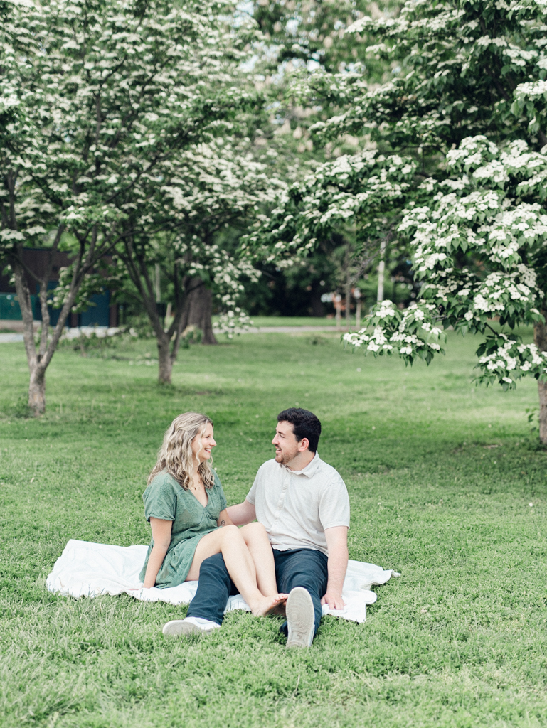 couple sitting together in Patterson Park by Baltimore wedding photographer