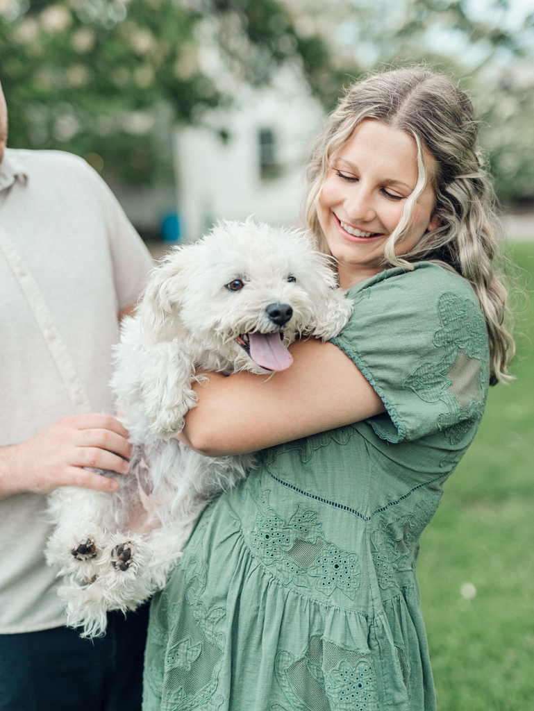 girl holding her dog during her engagement session by Baltimore wedding photographer