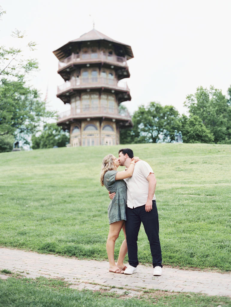 couple kissing during their engagement photos in Patterson Park by Baltimore wedding photographer