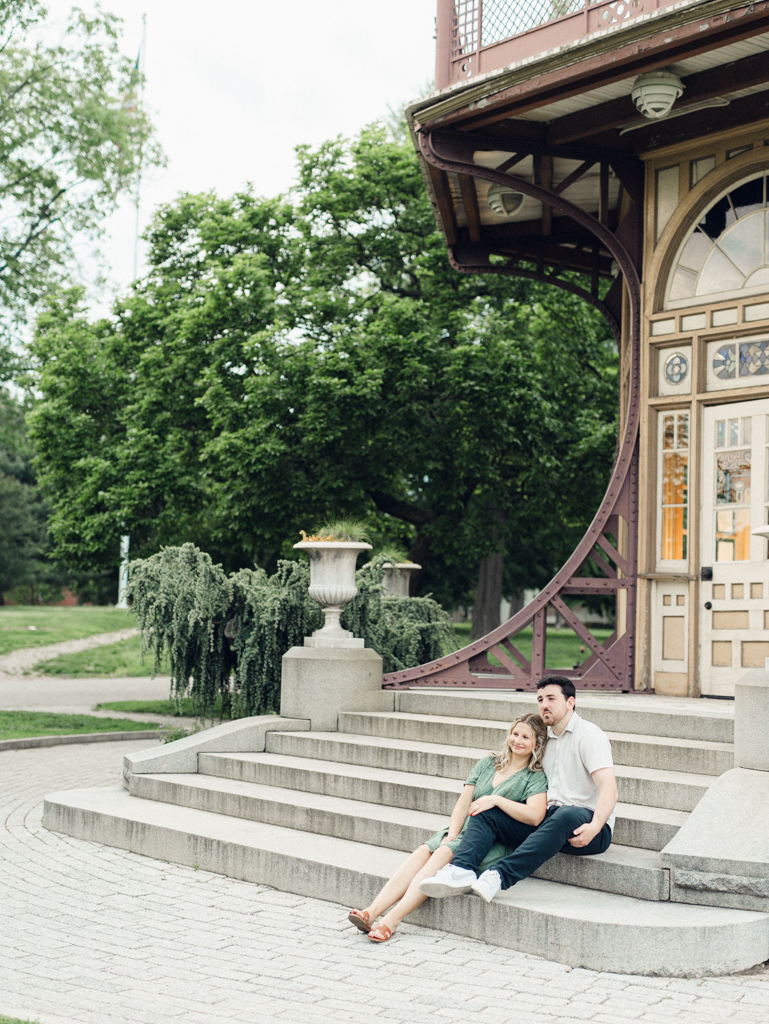 couple sitting on steps of Patterson Park Pagoda during their engagement photos by Baltimore wedding photographer