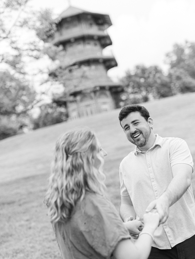 couple laughing and holding hands during their Patterson Park engagement session by Baltimore wedding photographer