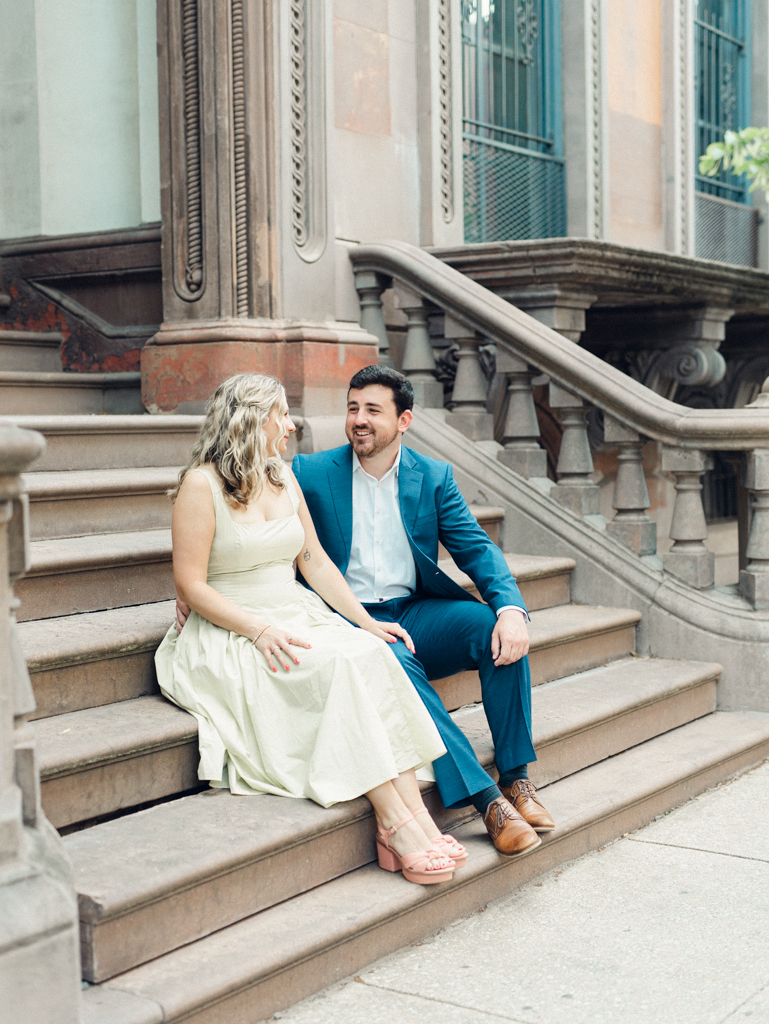 couple sitting on steps together in Mount Vernon Baltimore by Baltimore wedding photographer
