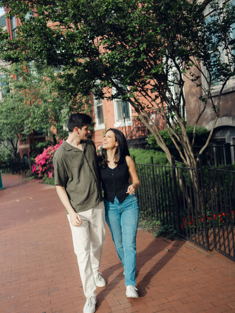couple walking together at Logan circle during their engagement session by dc film wedding photographer