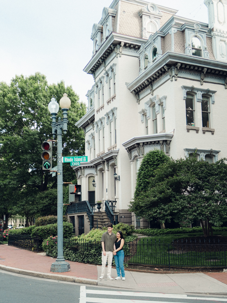 couple standing together at Logan circle during their engagement session by dc film wedding photographer