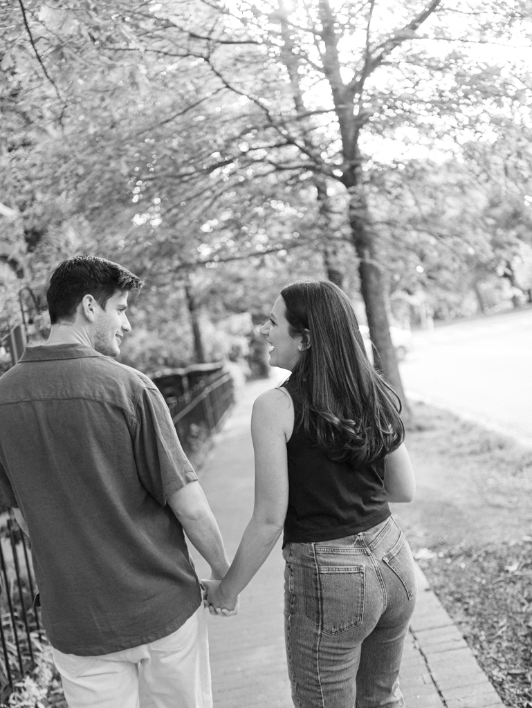 couple walking together at Logan circle during their engagement session by dc film wedding photographer