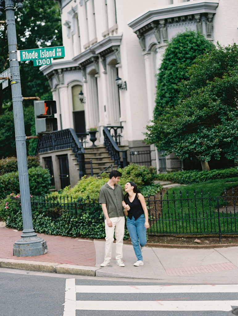 couple standing smiling together at Logan circle during their engagement session by dc film wedding photographer