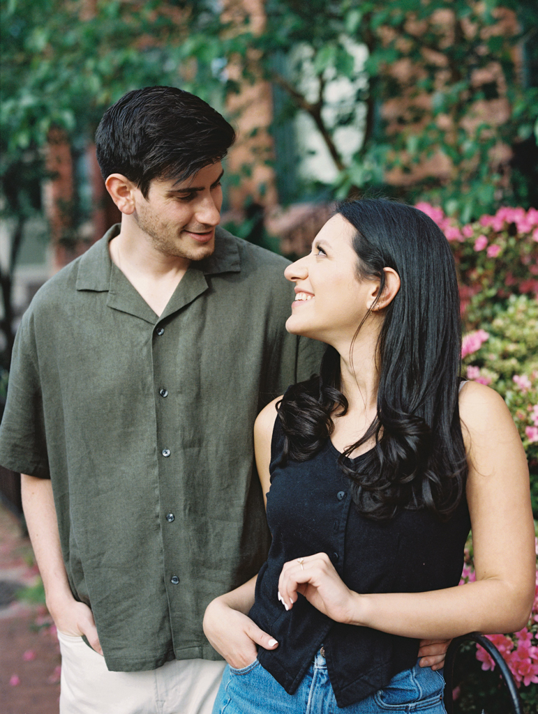 couple smiling together at Logan circle during their engagement session by dc film wedding photographer