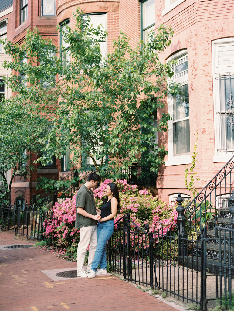 couple standing together at Logan circle during their engagement session by dc film wedding photographer