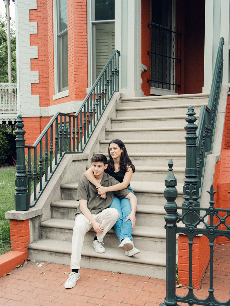 couple sitting together at Logan circle during their engagement session by dc film wedding photographer