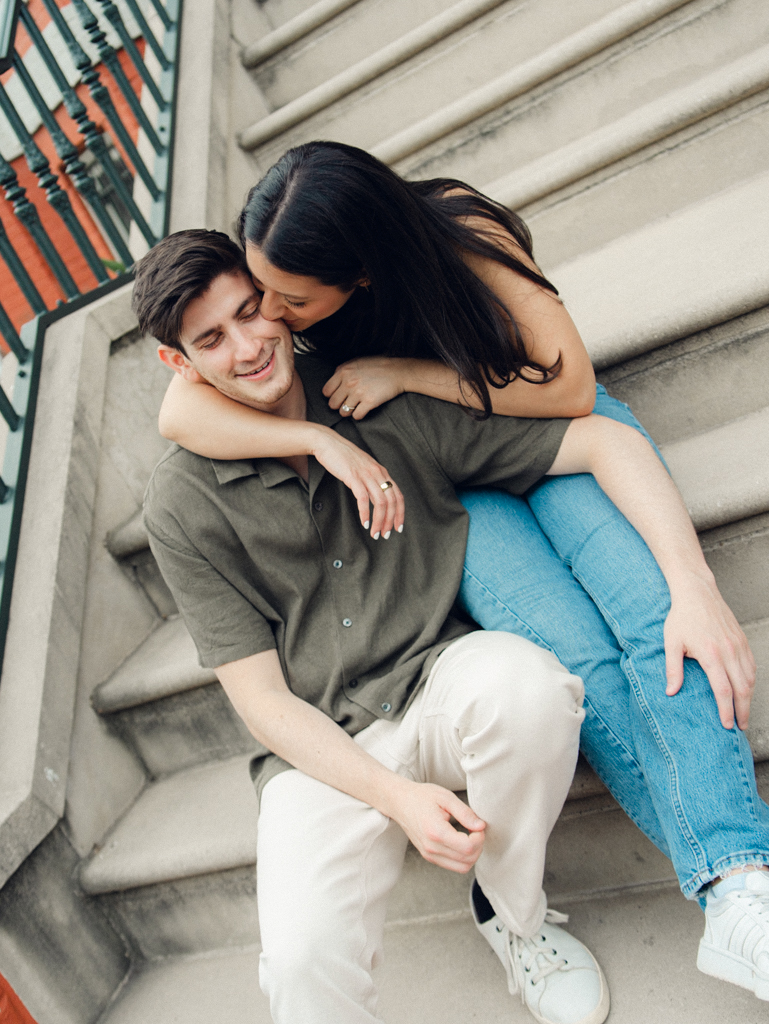 couple sitting together at Logan circle during their engagement session by dc film wedding photographer