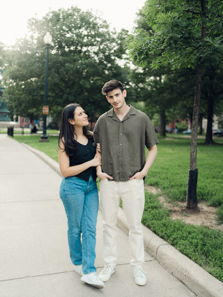 couple standing together at Logan circle during their engagement session by dc film wedding photographer
