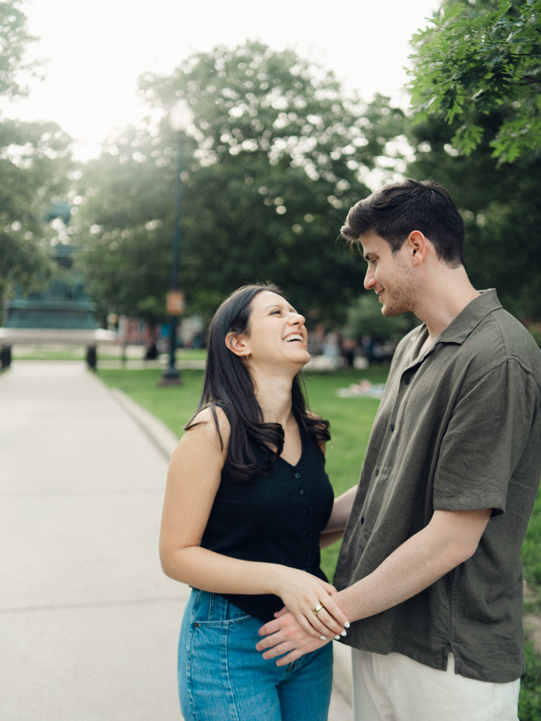 couple laughing together at Logan circle during their engagement session by dc film wedding photographer