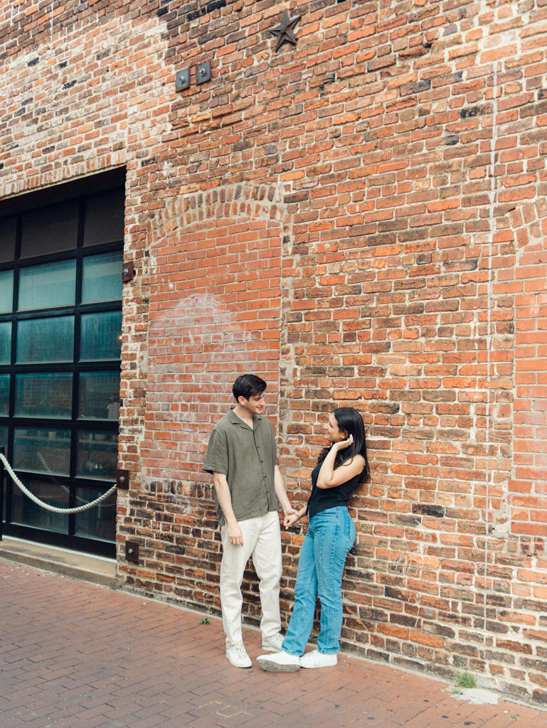 couple standing together during their engagements session in Blagden alley by dc film wedding photographer