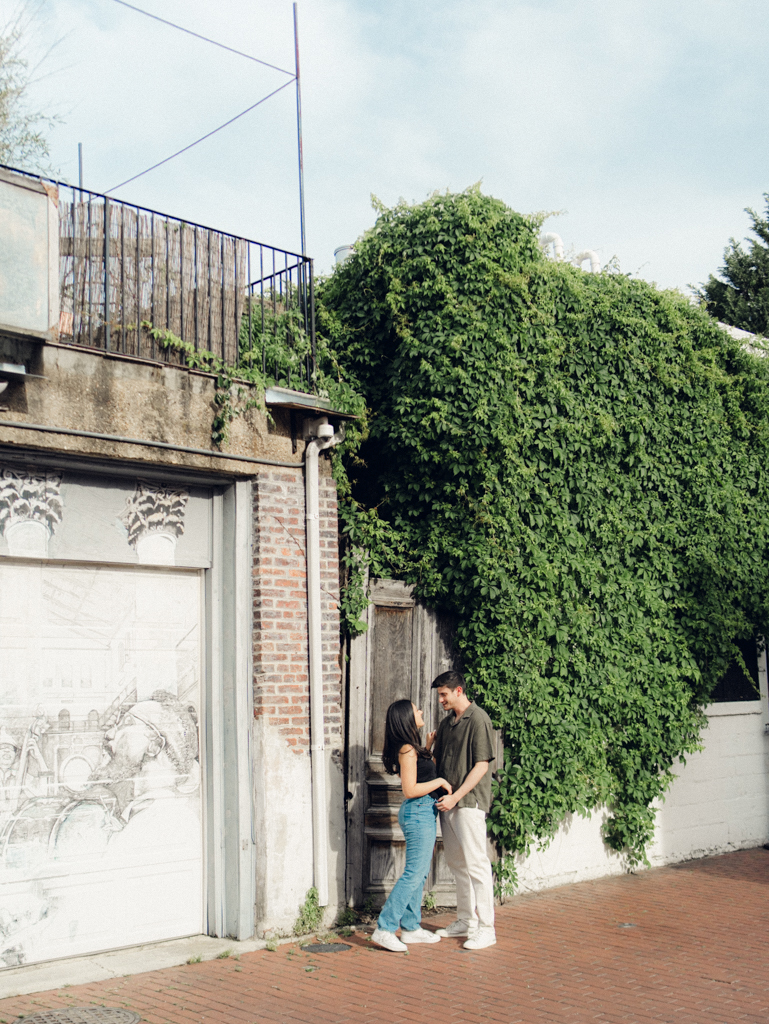 couple standing together during their engagements session in Blagden alley by dc film wedding photographer